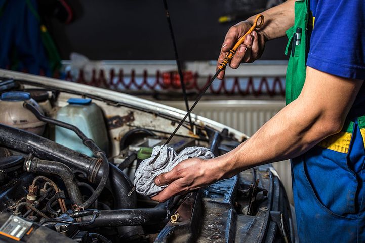 mechanic servicing car